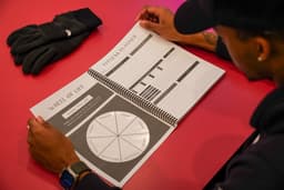 Student sitting at desk looking at planner with Wheel of Life and Fitness Planner pages shown.