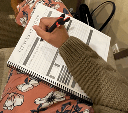 Woman filling out the Emotions Wheel page.