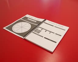 Planner laying on table with the Wheel of Life and Fitness Planner pages open.